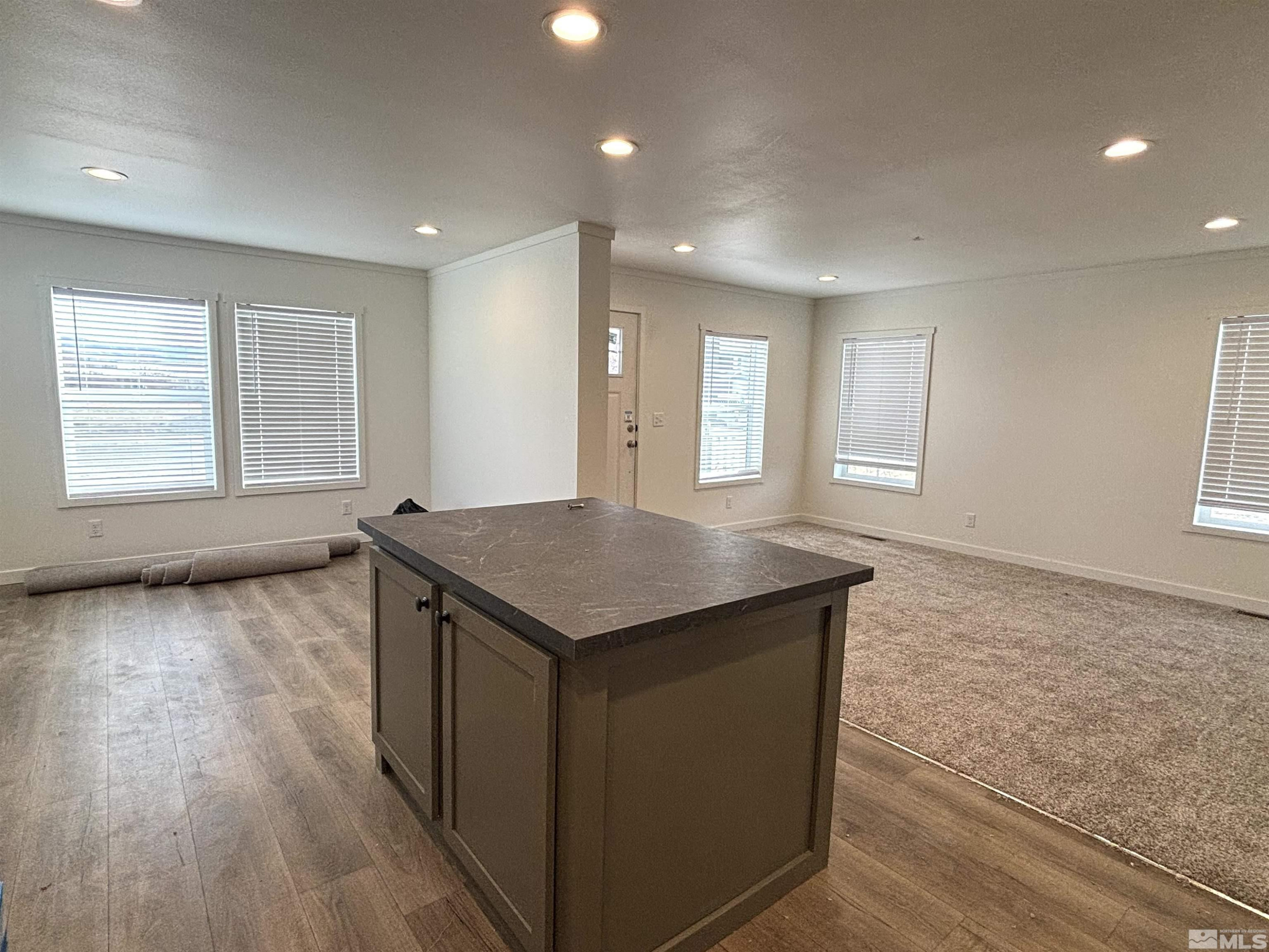 475 Camellia Way Lovelock, NV 89419 - Photo 11 of 23 an empty room with wooden floor and windows