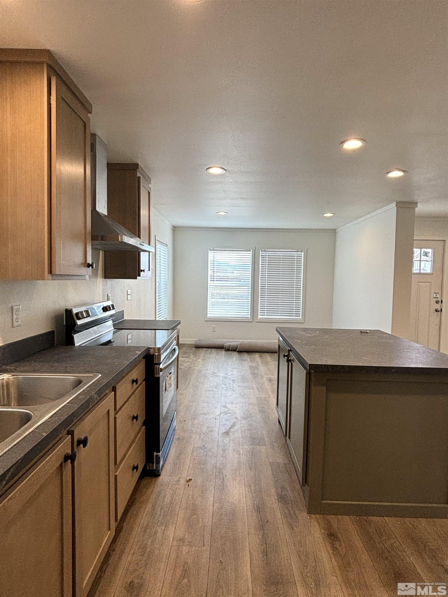 475 Camellia Way Lovelock, NV 89419 - Photo 12 of 23 a kitchen with stainless steel appliances granite countertop a sink stove and wooden floor