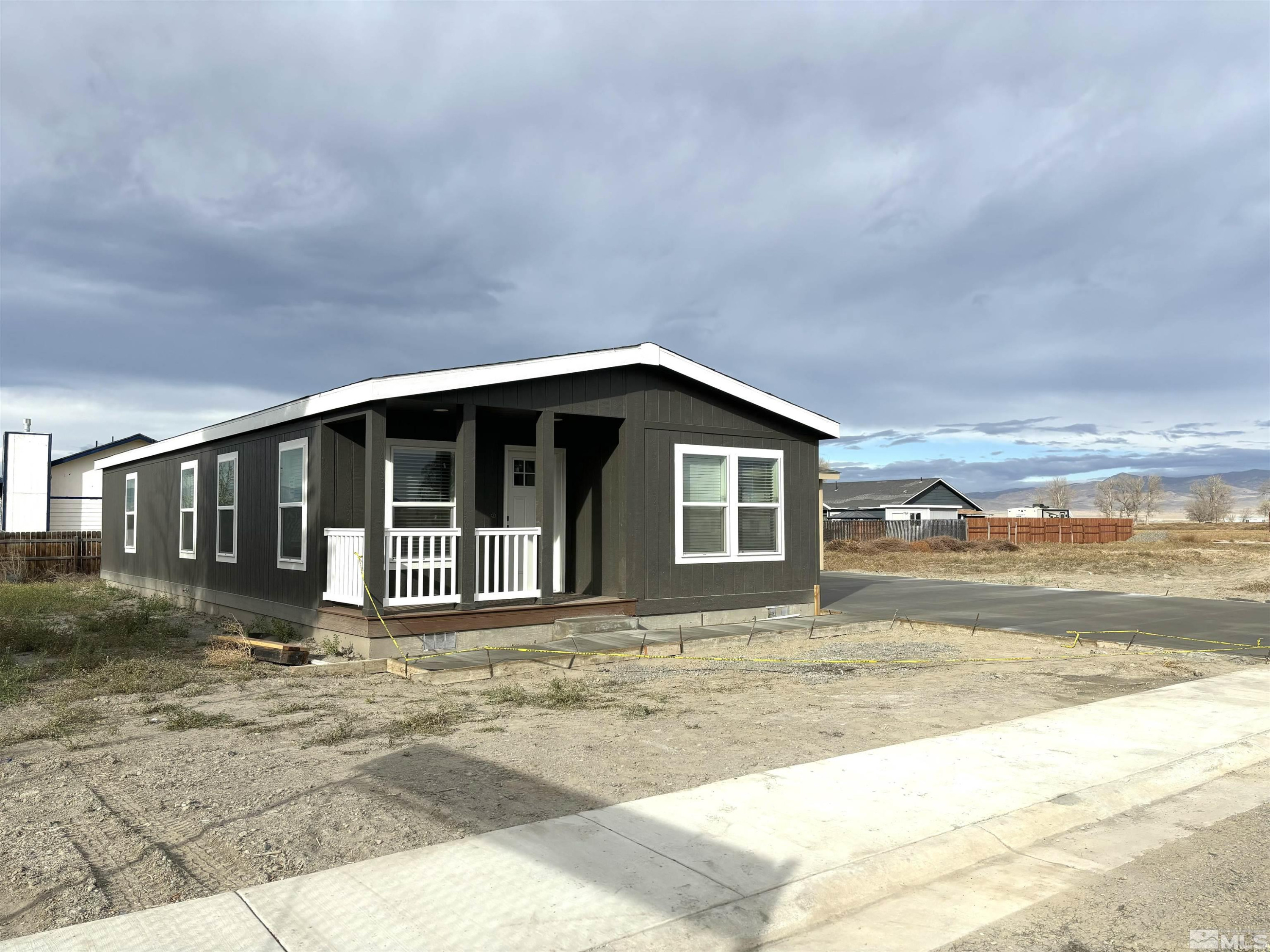 475 Camellia Way Lovelock, NV 89419 - Photo 2 of 23 a front view of a house with a yard