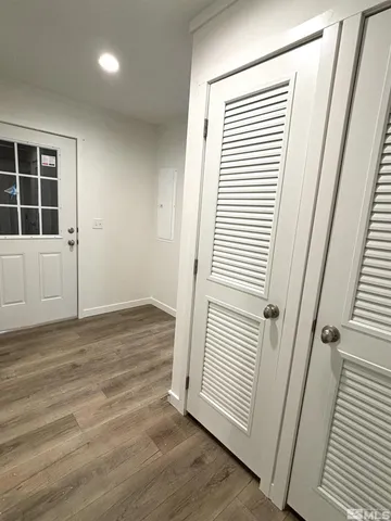 a view of a closet with wooden floor