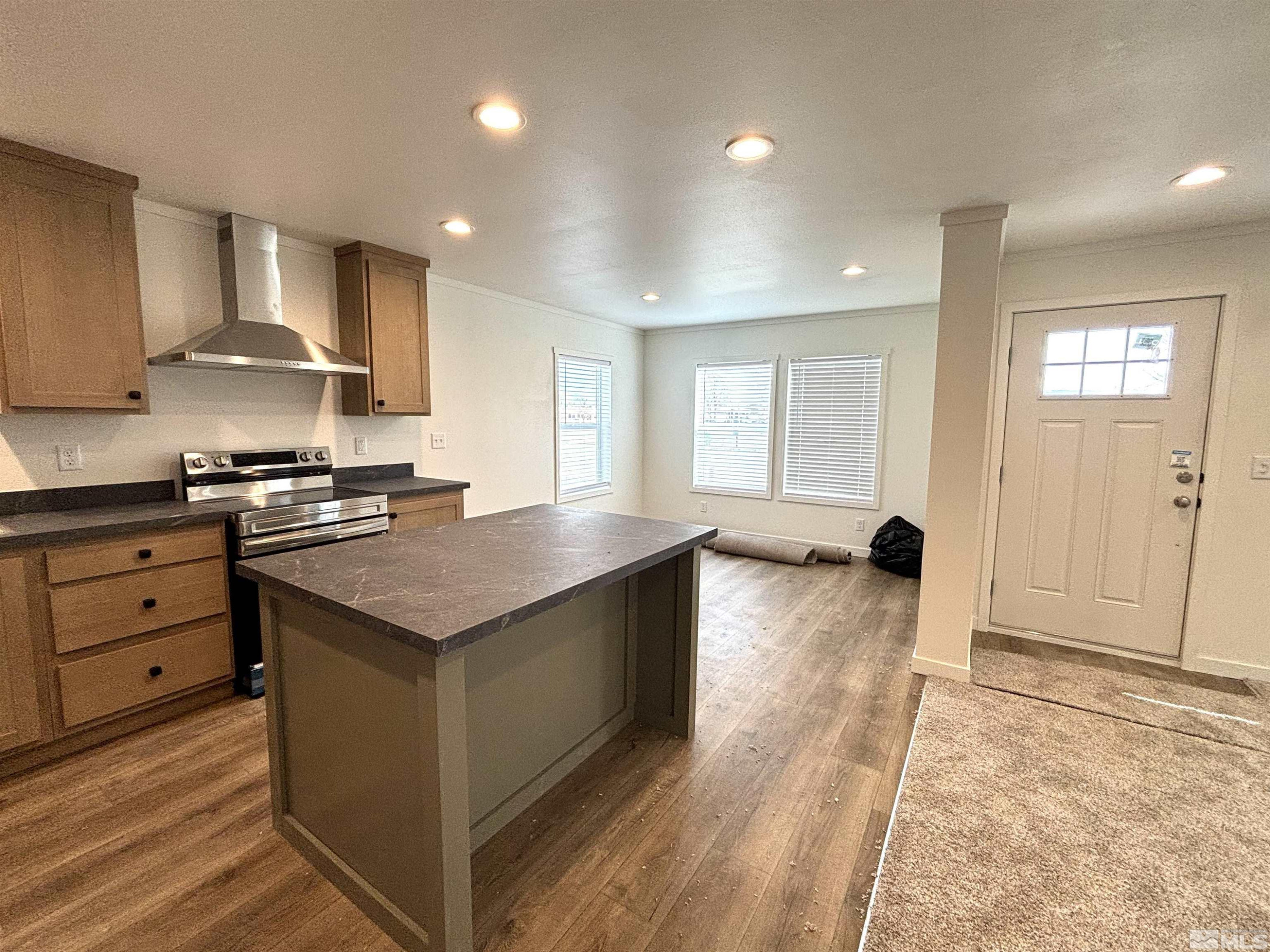 475 Camellia Way Lovelock, NV 89419 - Photo 5 of 23 a kitchen with stainless steel appliances granite countertop a stove and a sink