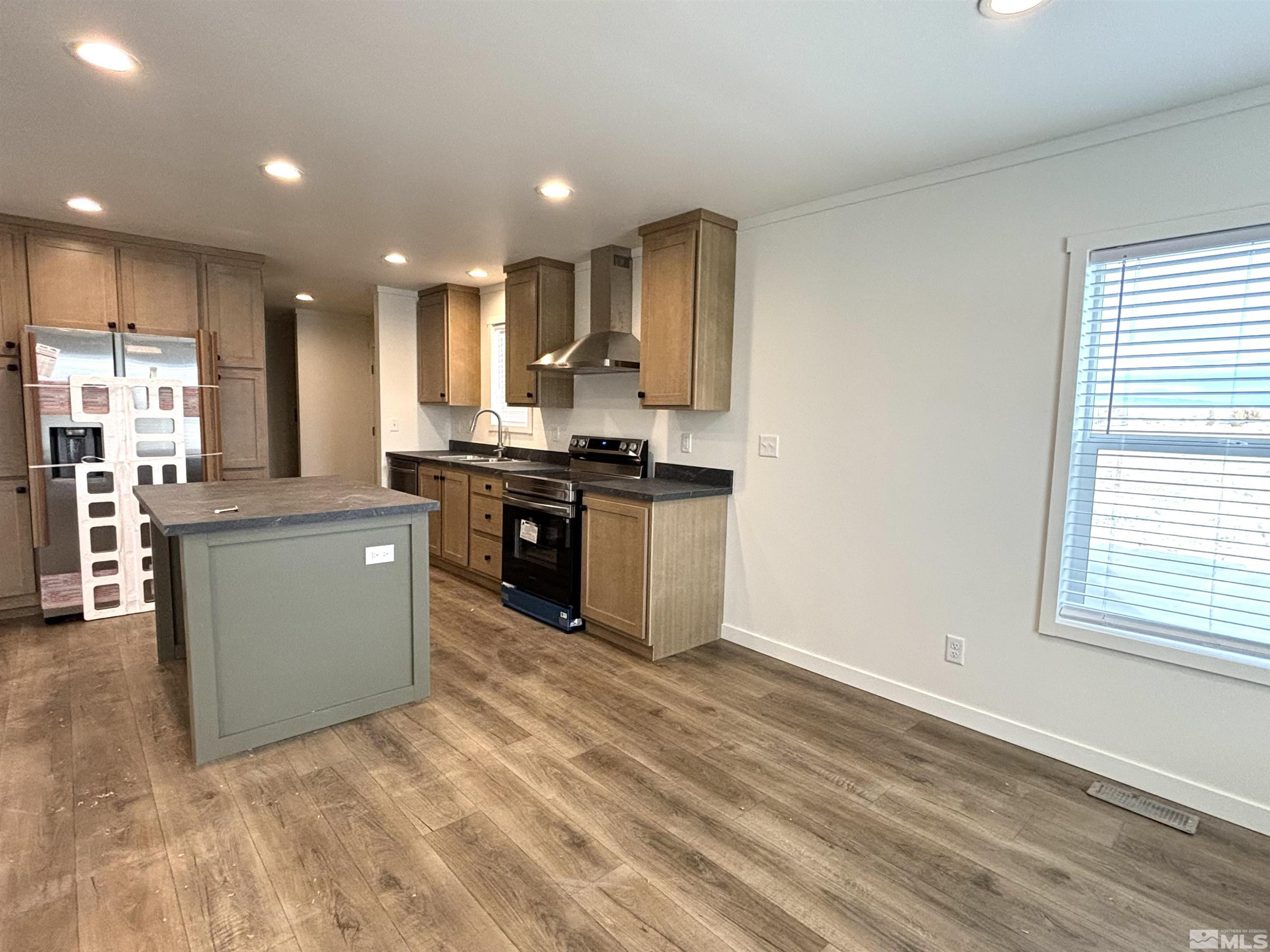 475 Camellia Way Lovelock, NV 89419 - Photo 7 of 23 a kitchen with stainless steel appliances granite countertop a stove top oven a sink and a refrigerator