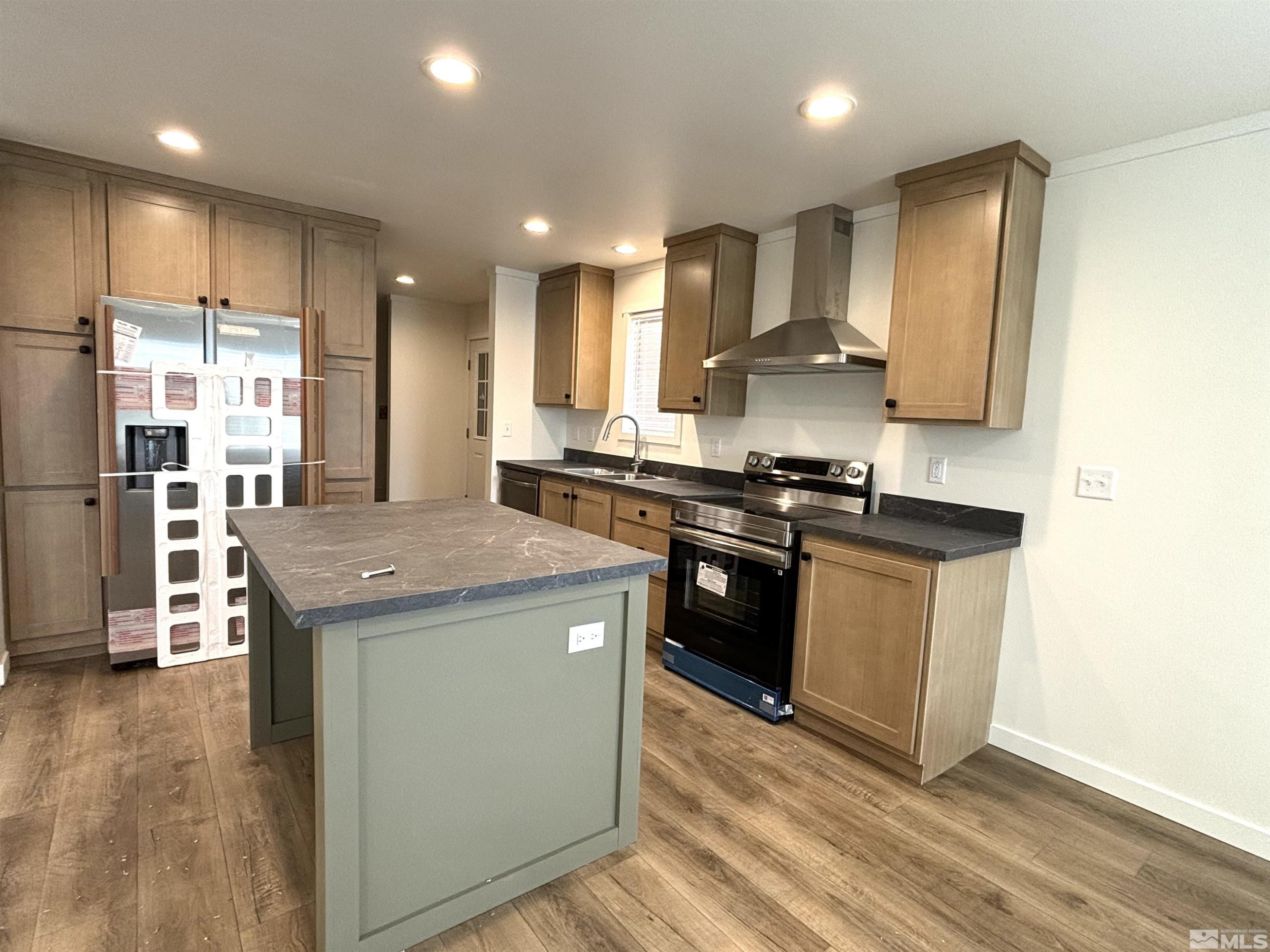 475 Camellia Way Lovelock, NV 89419 - Photo 8 of 23 a kitchen with stainless steel appliances granite countertop a sink stove and refrigerator