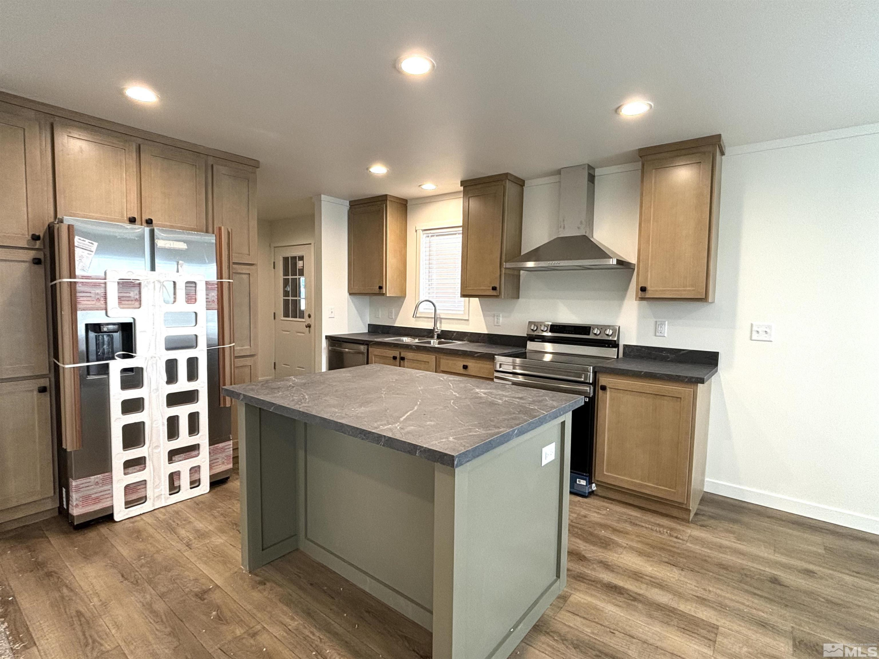 475 Camellia Way Lovelock, NV 89419 - Photo 9 of 23 a kitchen with stainless steel appliances granite countertop a stove a sink and a refrigerator