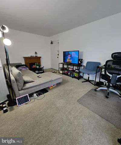 a bedroom with furniture and a flat screen tv