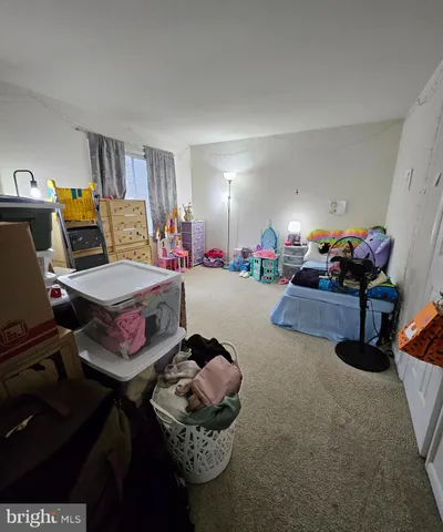 a room with furniture a rug and gym equipment