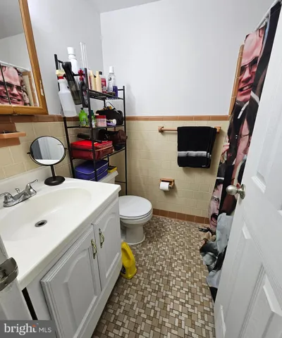 a bathroom with a sink mirror vanity and toilet