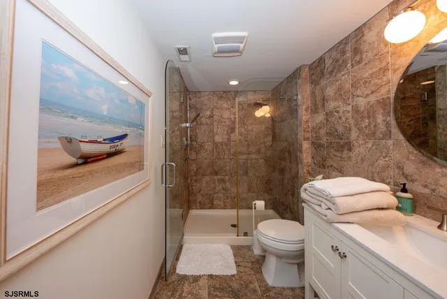 a bathroom with a toilet a sink and shower