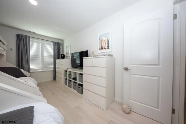 a view of a bedroom with furniture and windows
