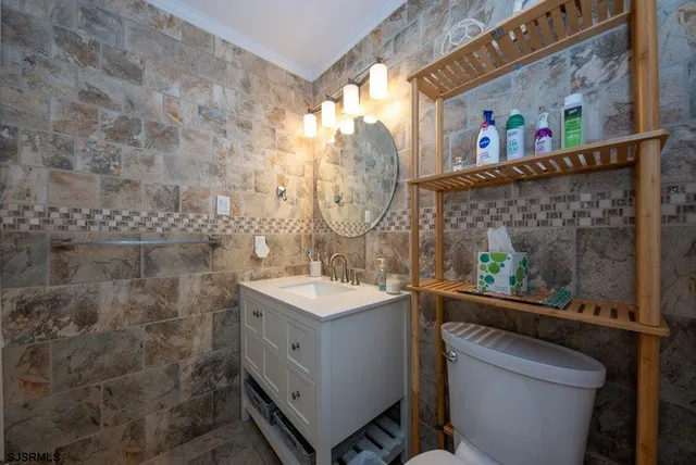 a bathroom with a sink mirror and toilet
