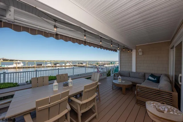 a view of a balcony with furniture and a wooden floor