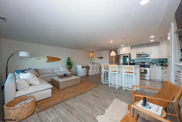 a living room with furniture and kitchen view