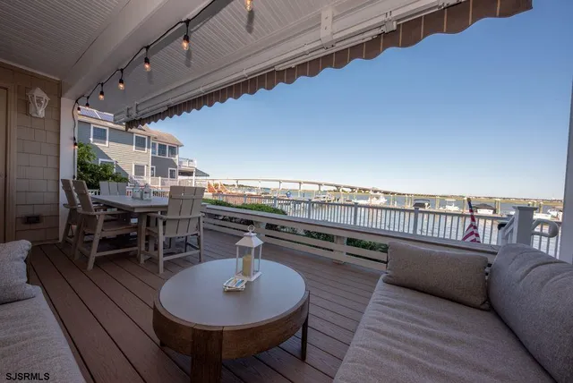 a balcony with table and chairs