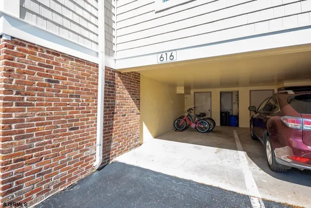 a view of a garage with rack and bicycle