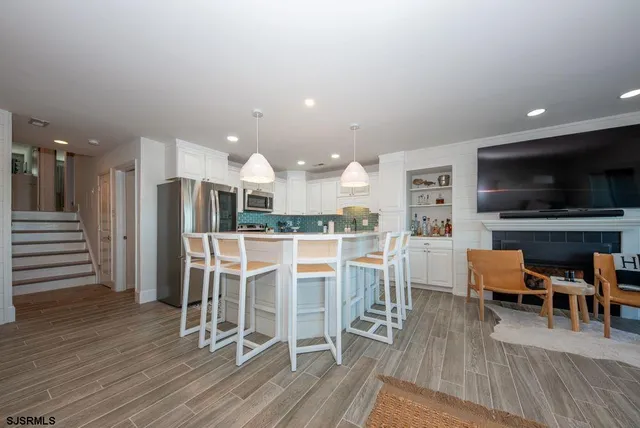 a dining room with furniture and wooden floor