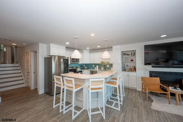 a dining room with furniture and wooden floor