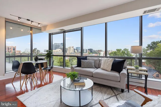 a living room with furniture kitchen and a table