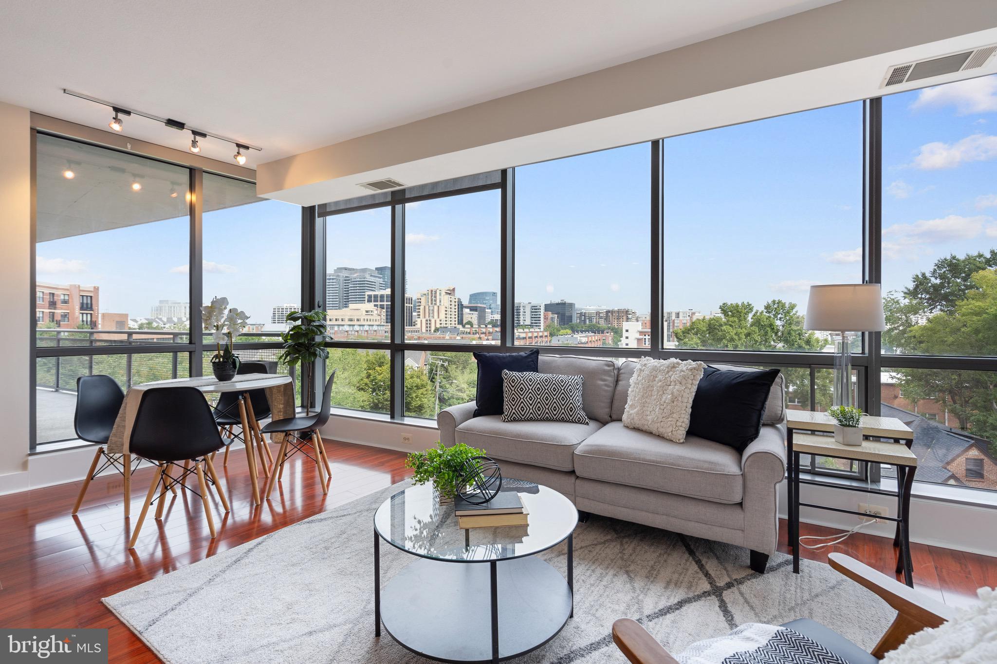 2001 15th Street North, Unit 306 Arlington, VA 22201 - Photo 17 of 56 a living room with furniture and a floor to ceiling window