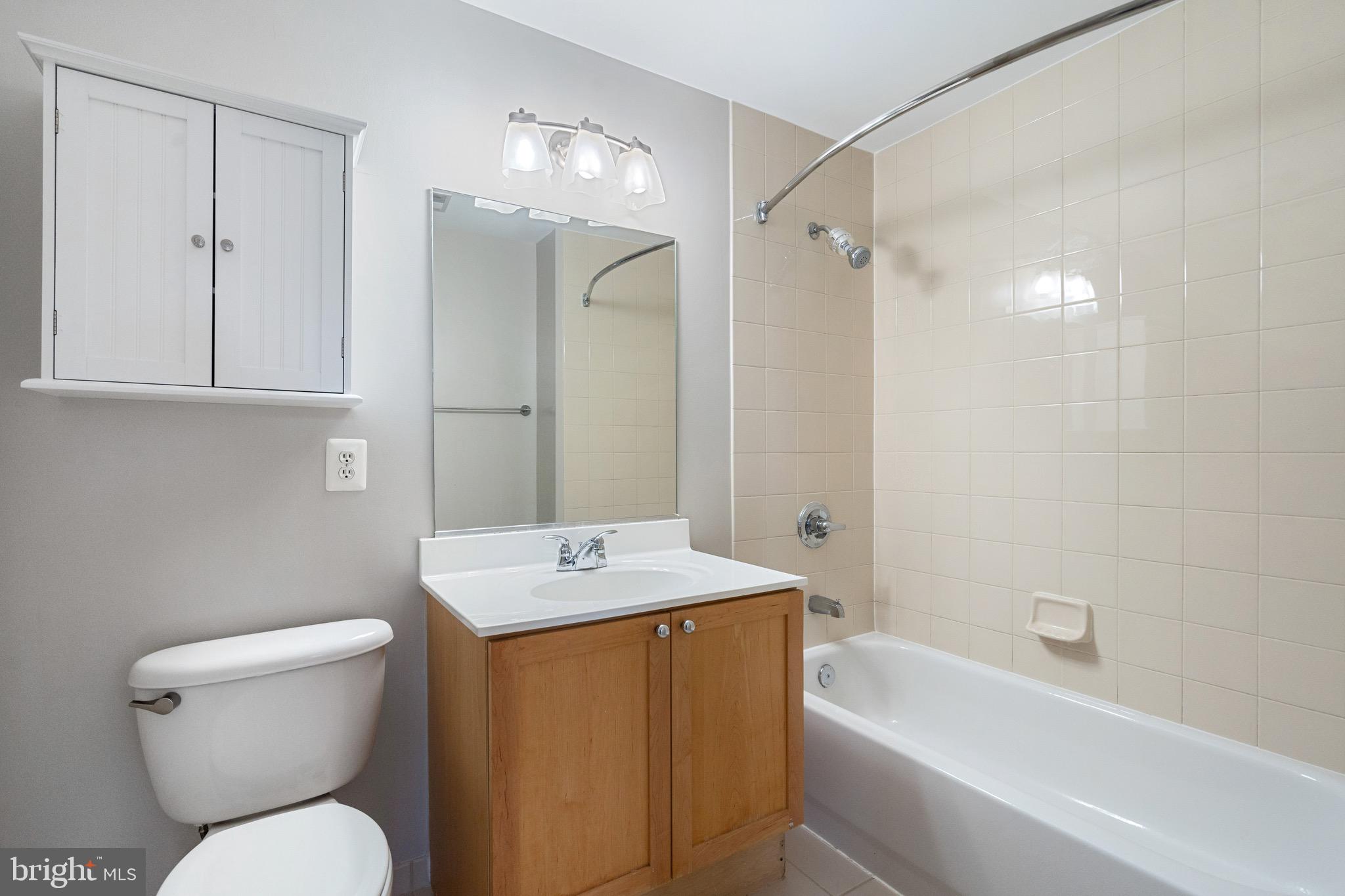 2001 15th Street North, Unit 306 Arlington, VA 22201 - Photo 34 of 56 a bathroom with a sink toilet vanity and shower