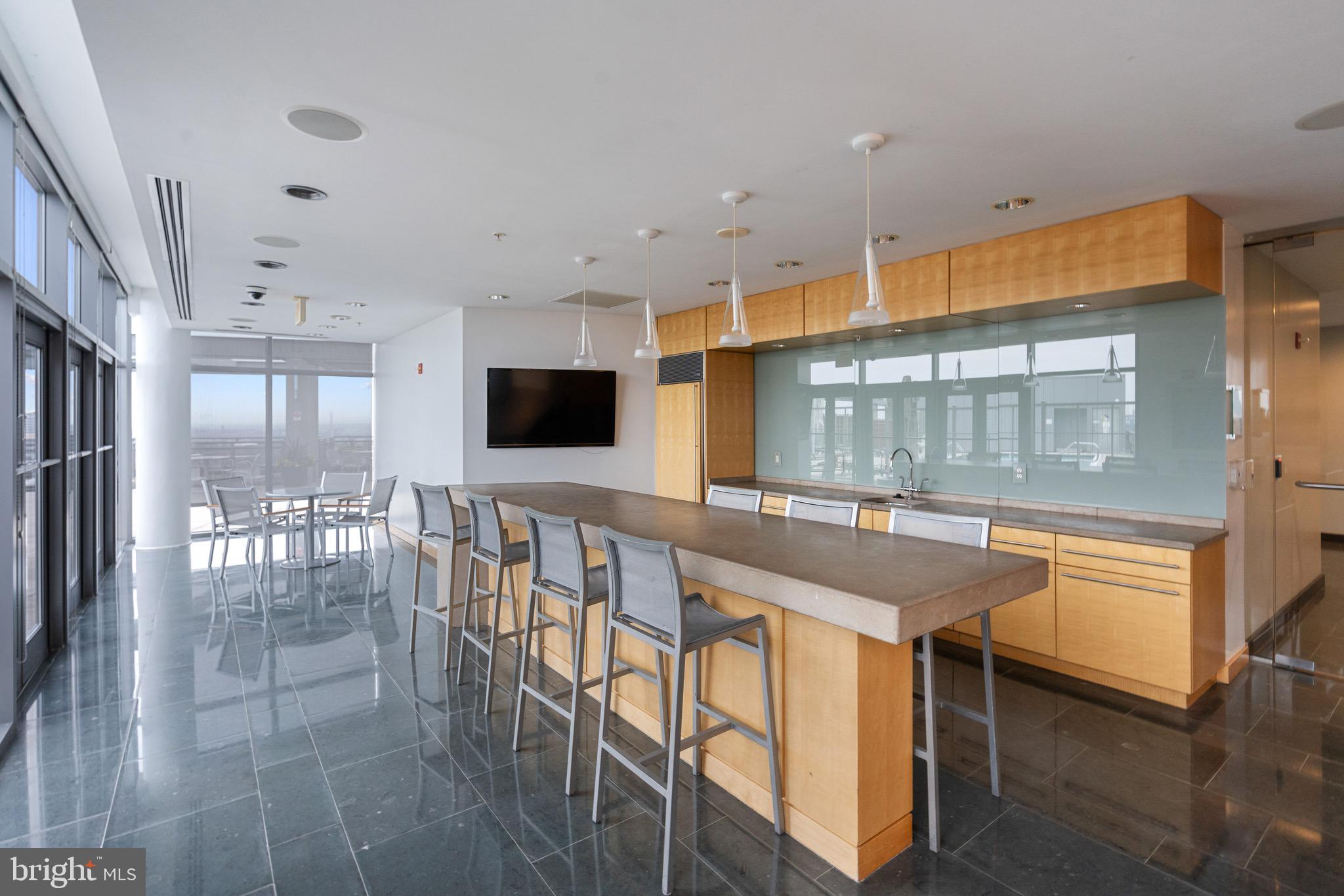 2001 15th Street North, Unit 306 Arlington, VA 22201 - Photo 42 of 56 a dining hall with stainless steel appliances granite countertop a stove and a view of living room with windows