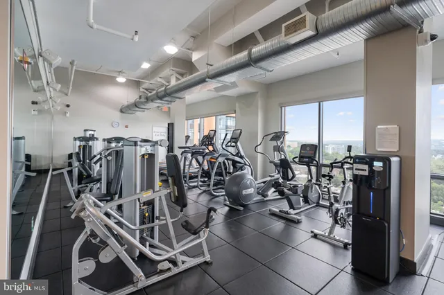 a living room with furniture and floor to ceiling window