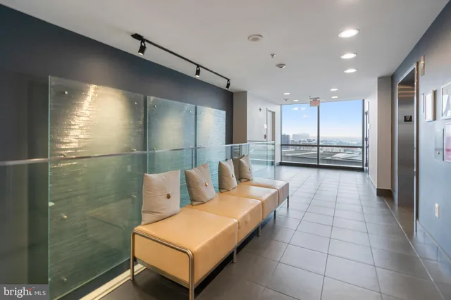 a lobby with furniture and large windows