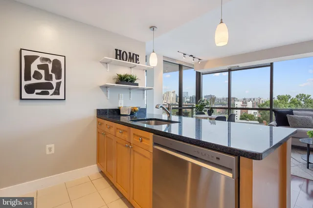 a kitchen with stainless steel appliances granite countertop a refrigerator and a microwave
