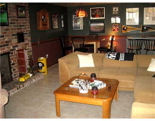 1869 Swallow Hill Road Pittsburgh, PA 15220 - Photo 14 of 18 Den/Family/Great Room. This existing "Sportsman s Cave", or multi-purpose family room, has an easy-care ceramic floor and a handsome brick fireplace and hearth with a firewood storage area.