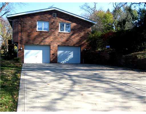 1869 Swallow Hill Road Pittsburgh, PA 15220 - Photo 18 of 18 Exterior Back. The easy access concrete driveway at the side of the house leads to the over-sized garage. There is a brick wall, at the right, with steps that go to the gated patio and yard.