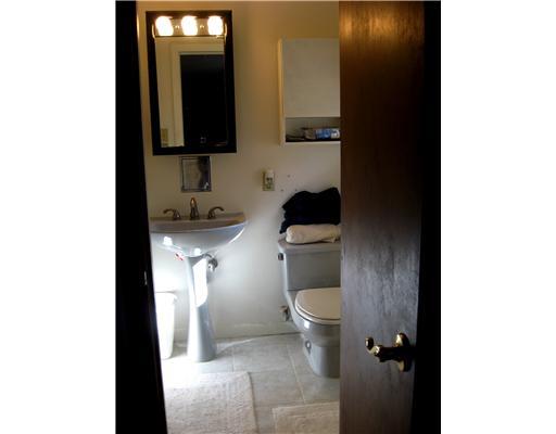 1869 Swallow Hill Road Pittsburgh, PA 15220 - Photo 10 of 18 Master Bath/Spa. The gray and white ceramic floor highlights the gray commode and pedestal sink with the black-framed medicine chest above. The walk-in shower is to the left.