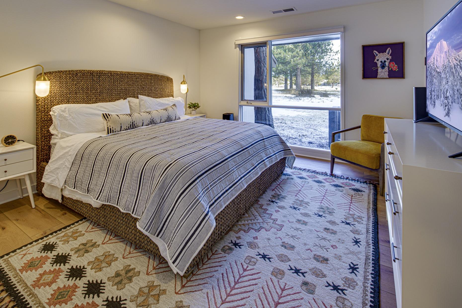 57257 Island Road Sunriver, OR 97707 - Photo 17 of 27 a bedroom with a bed and wooden floor