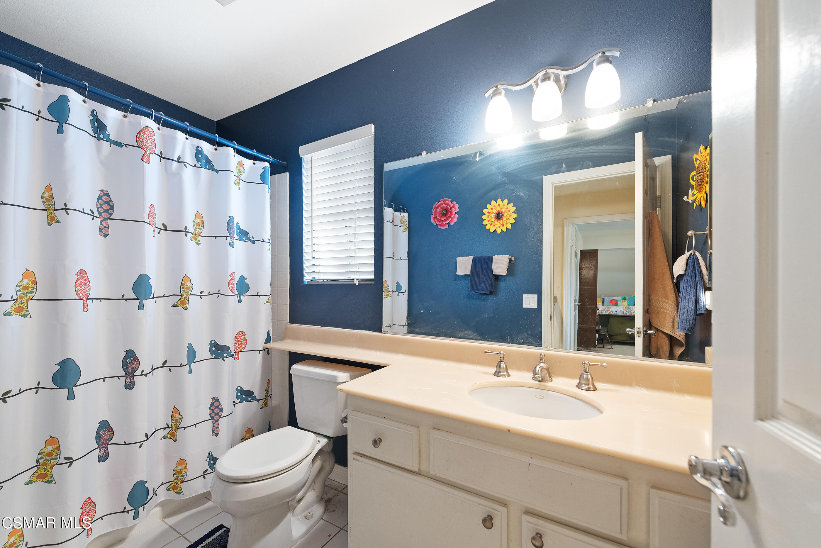 6464 Hazel Circle Simi Valley, CA 93063 - Photo 29 of 42 a bathroom with a sink a toilet a mirror a vanity and shower