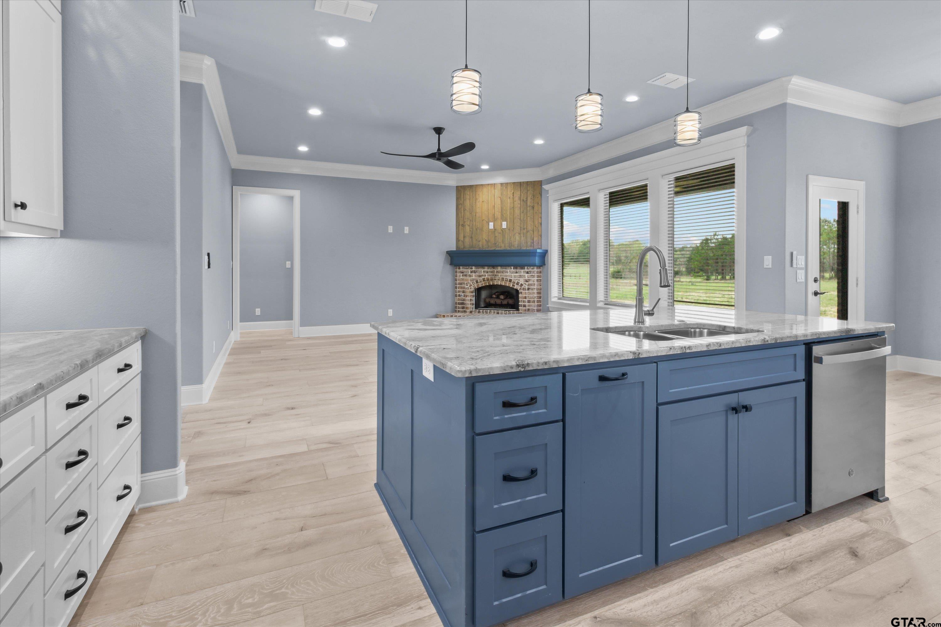 11236 Bryce Circle Flint, TX 75762 - Photo 17 of 44 an open kitchen with a sink and dishwasher with a large kitchen island