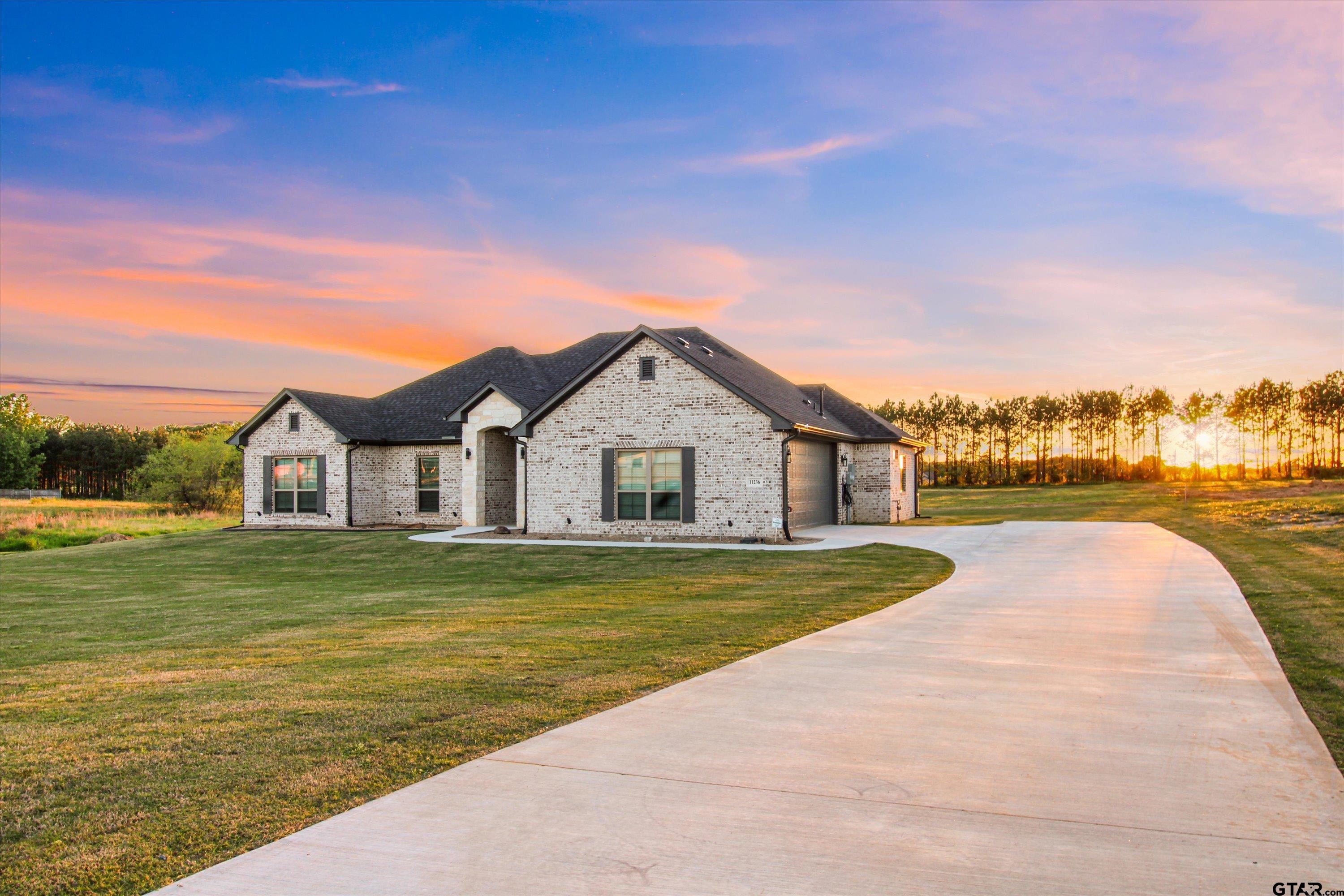 11236 Bryce Circle Flint, TX 75762 - Photo 3 of 44 a front view of a house with a yard and lake