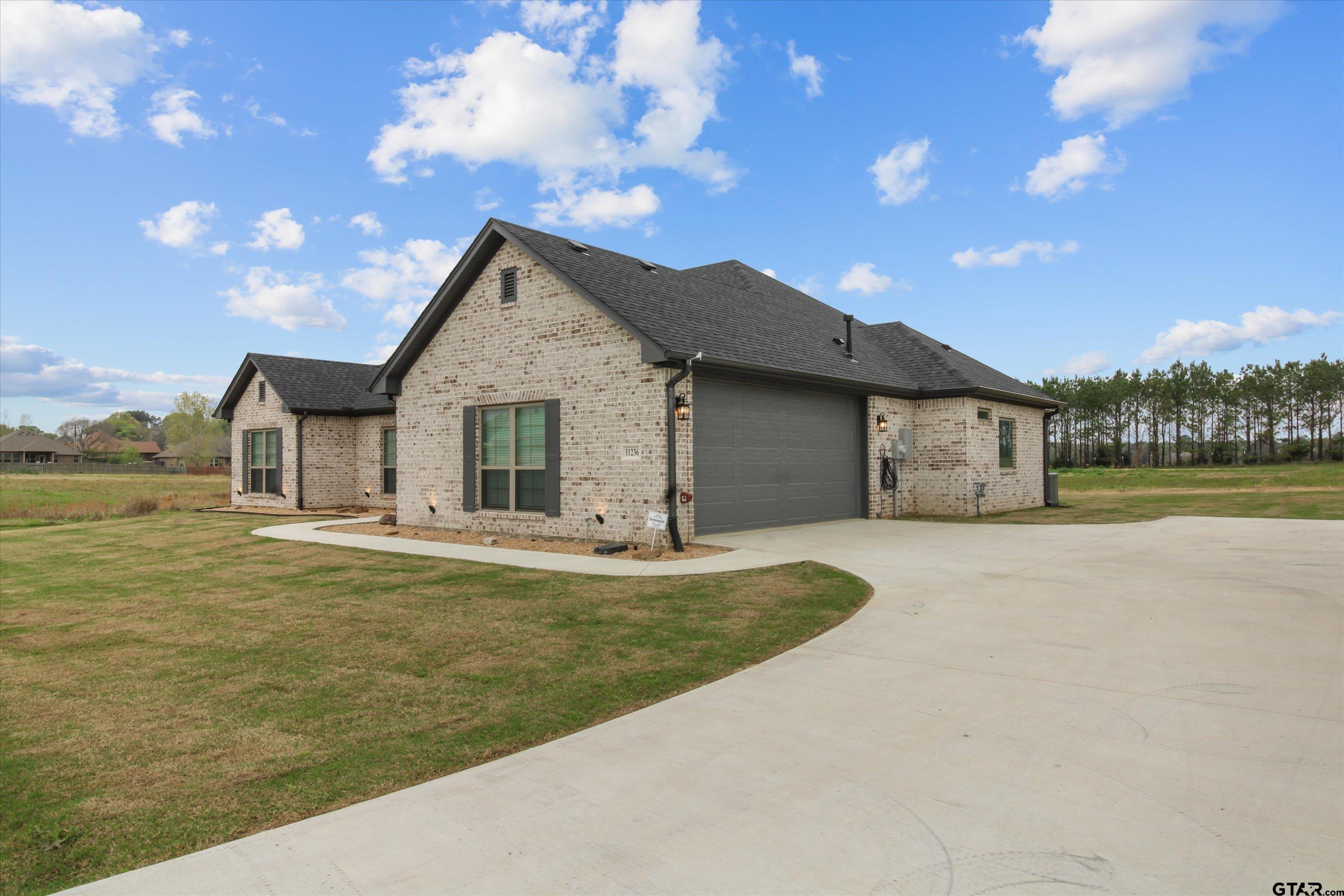 11236 Bryce Circle Flint, TX 75762 - Photo 42 of 44 a front view of a house with a garden and yard