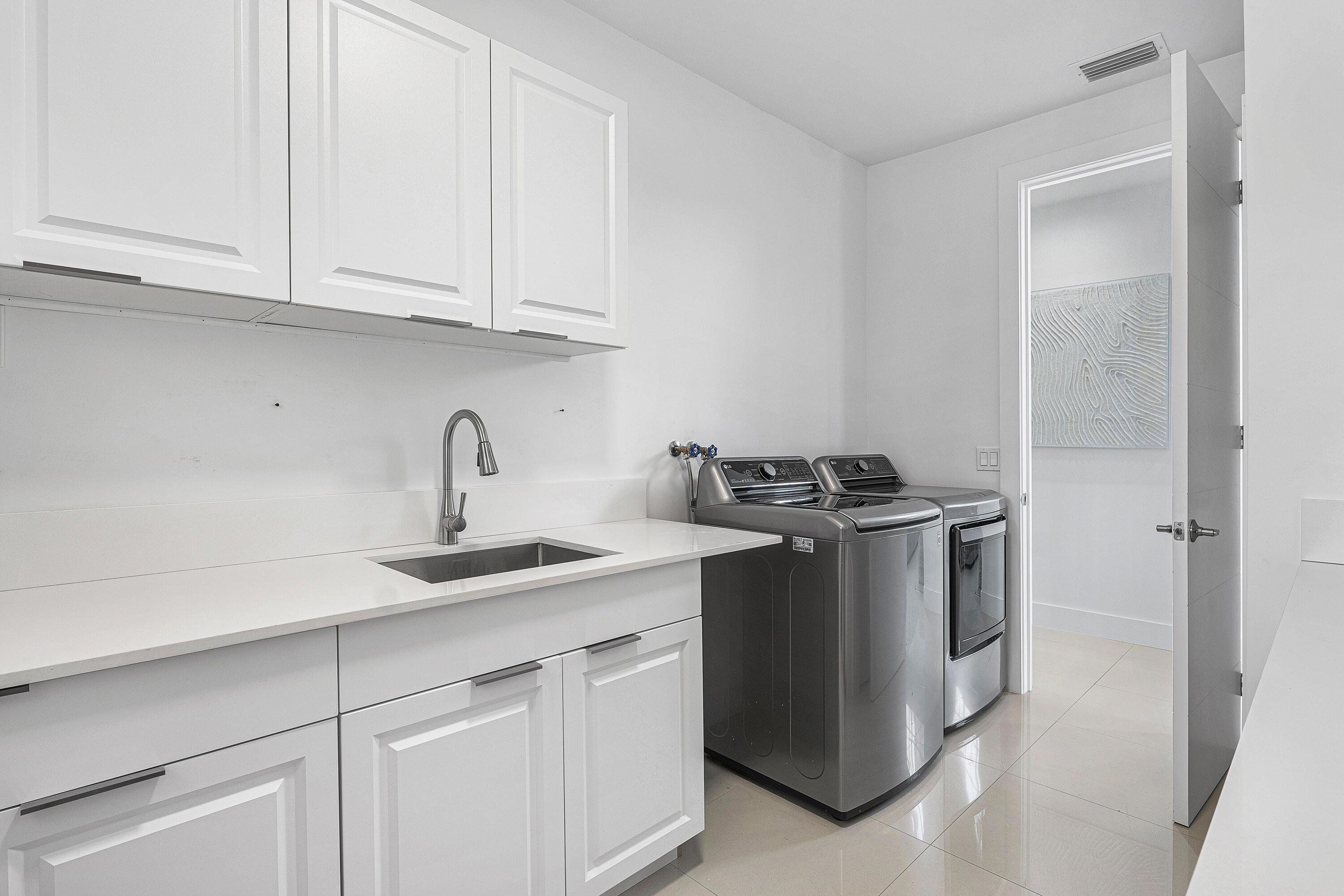 2197 Northwest 59th Street Boca Raton, FL 33496 - Photo 16 of 62 a kitchen with stainless steel appliances granite countertop a sink and a white cabinets
