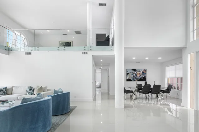 a living room with furniture and view of kitchen