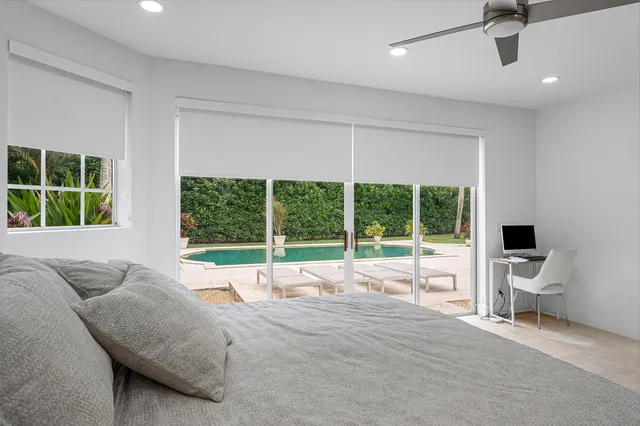 a bed sitting in a bedroom next to a window