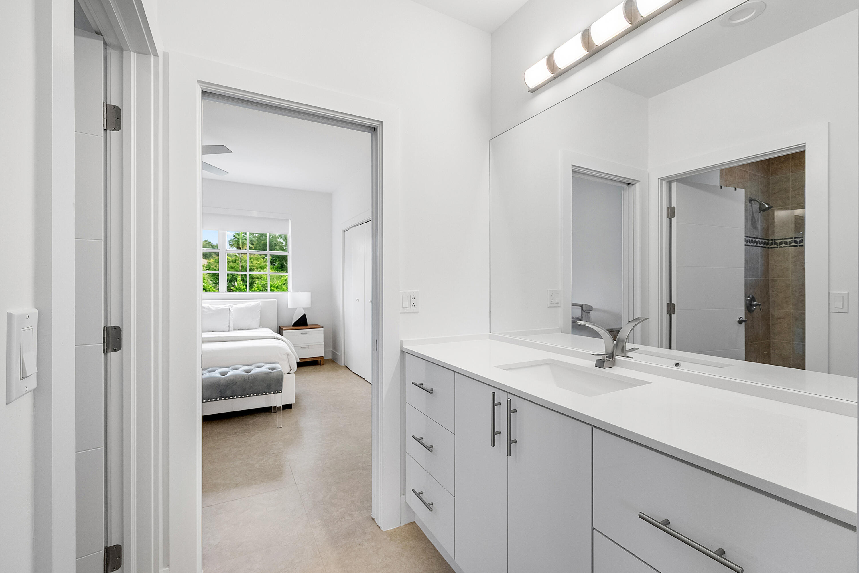 2197 Northwest 59th Street Boca Raton, FL 33496 - Photo 22 of 62 a en suite bathroom with a double vanity sink and mirror