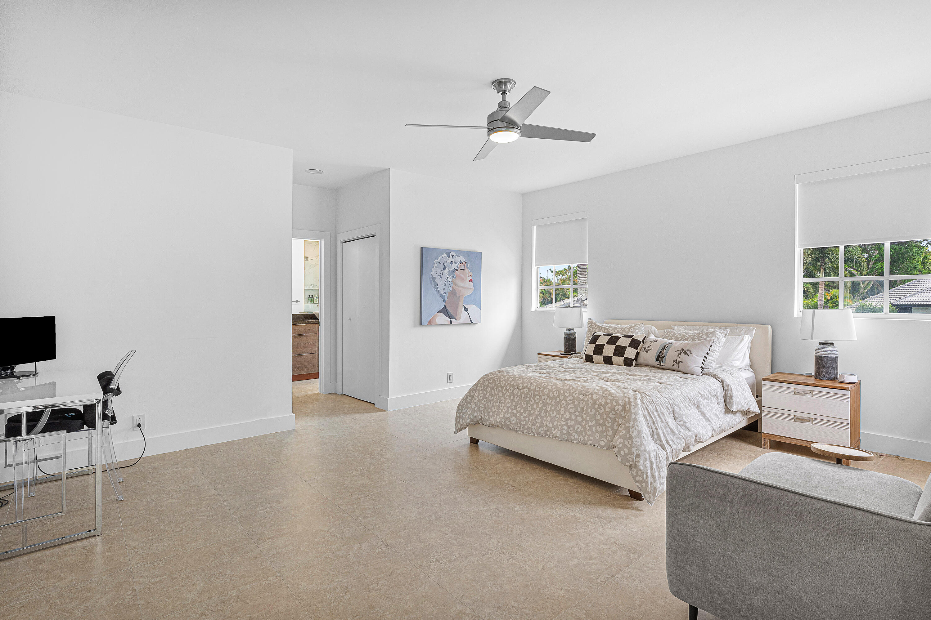 2197 Northwest 59th Street Boca Raton, FL 33496 - Photo 32 of 62 a spacious bedroom with a bed and table chair