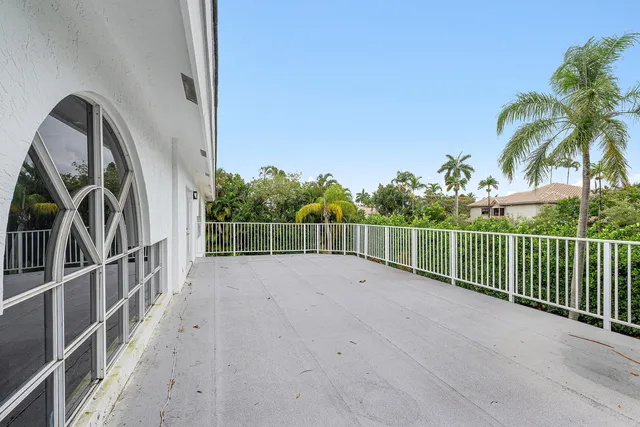 a view of a house with a yard and potted plants