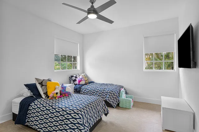 a living room with furniture a fireplace and a chandelier