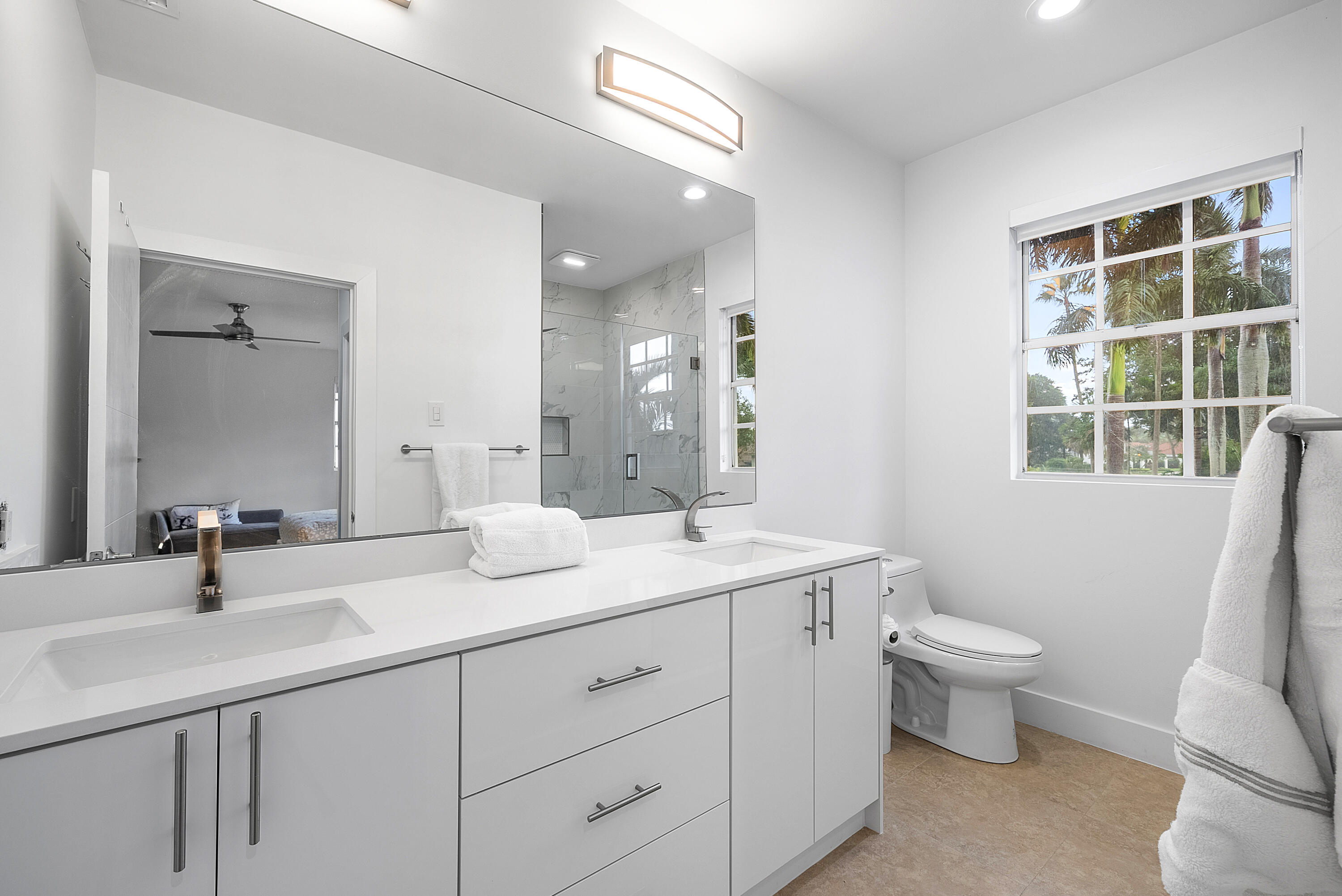 2197 Northwest 59th Street Boca Raton, FL 33496 - Photo 38 of 62 a bathroom with a double vanity sink toilet and a mirror