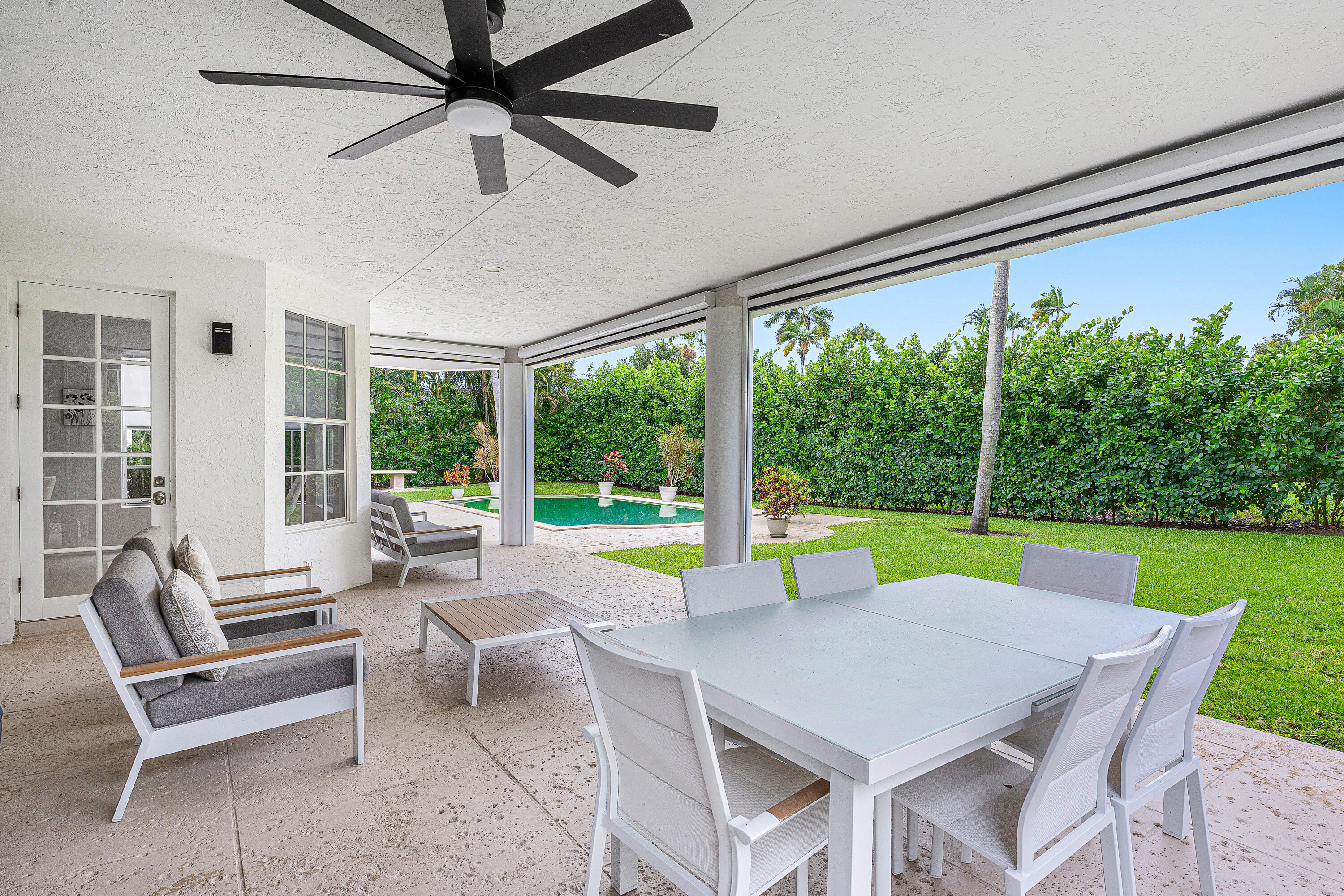 2197 Northwest 59th Street Boca Raton, FL 33496 - Photo 40 of 62 a view of a patio with a table chairs and a swimming pool