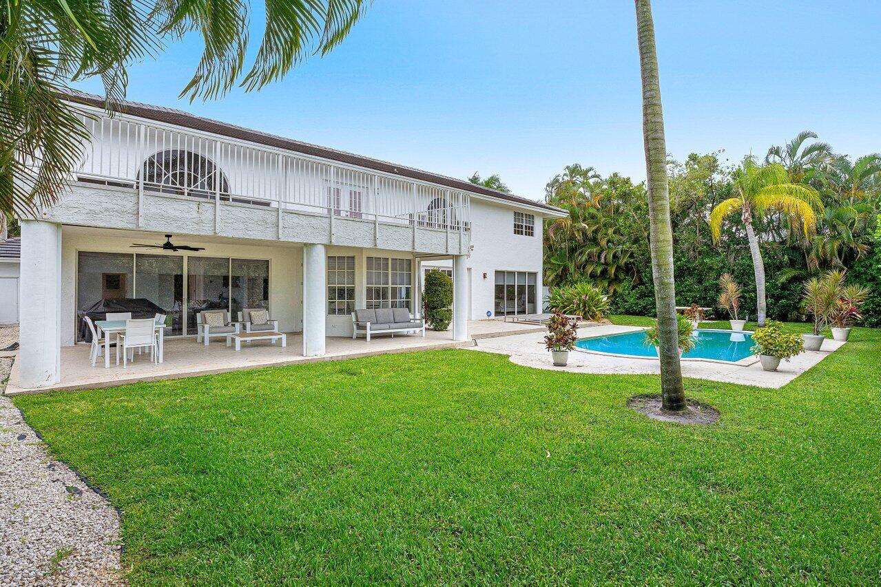 2197 Northwest 59th Street Boca Raton, FL 33496 - Photo 41 of 62 a swimming pool with outdoor seating and yard