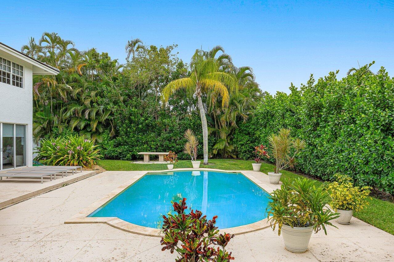 2197 Northwest 59th Street Boca Raton, FL 33496 - Photo 42 of 62 a view of a swimming pool with a yard