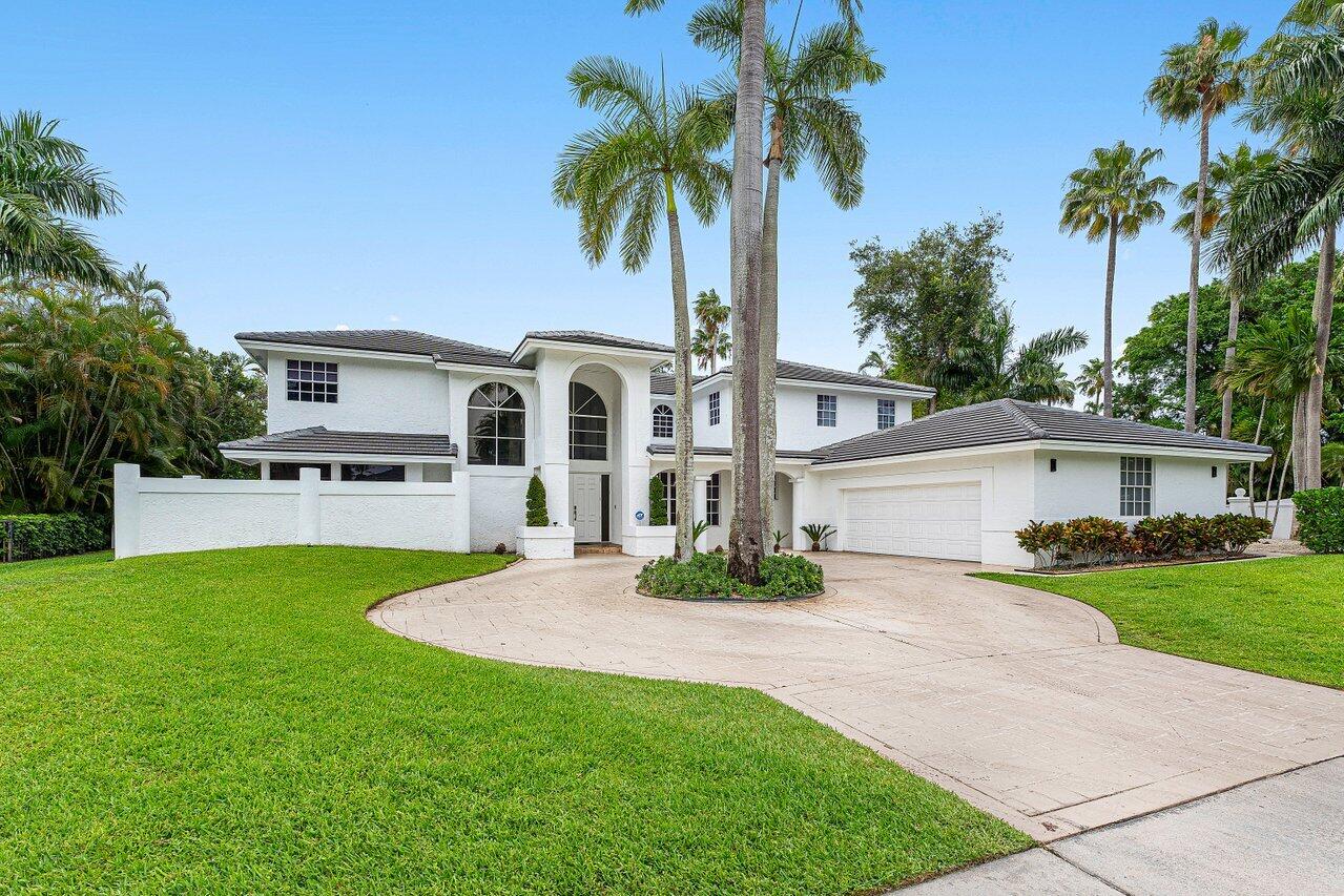 2197 Northwest 59th Street Boca Raton, FL 33496 - Photo 44 of 62 a front view of a house with a garden and yard