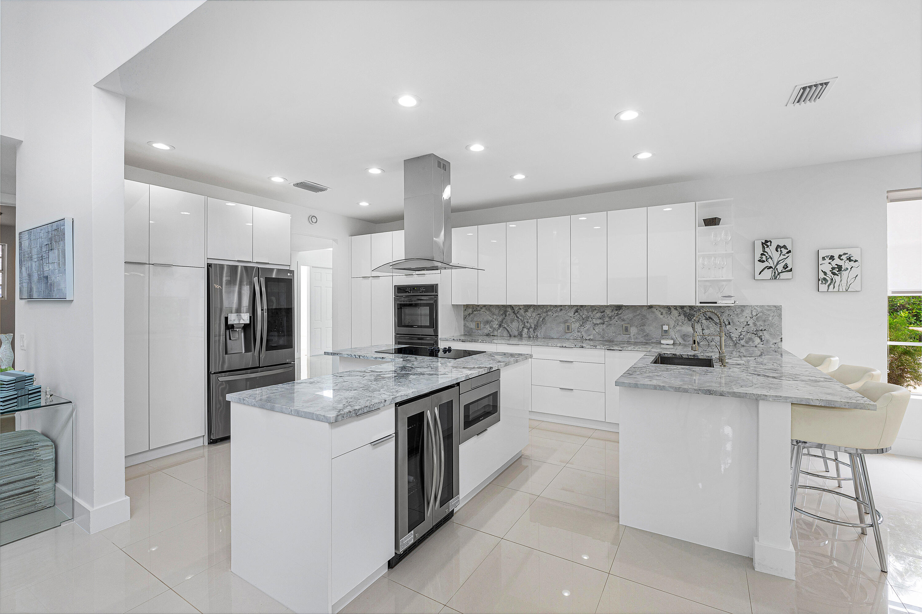 2197 Northwest 59th Street Boca Raton, FL 33496 - Photo 10 of 62 a kitchen with stainless steel appliances granite countertop a stove top oven a sink and a refrigerator