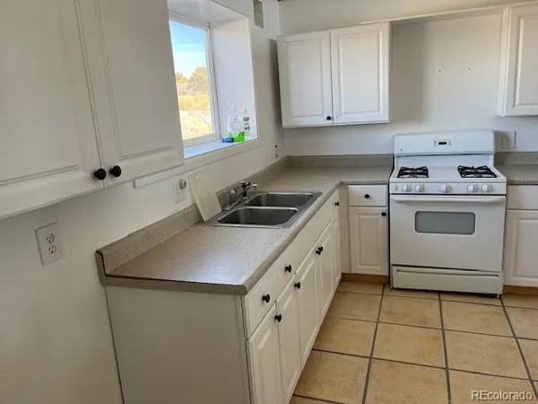 a kitchen with a stove and a refrigerator