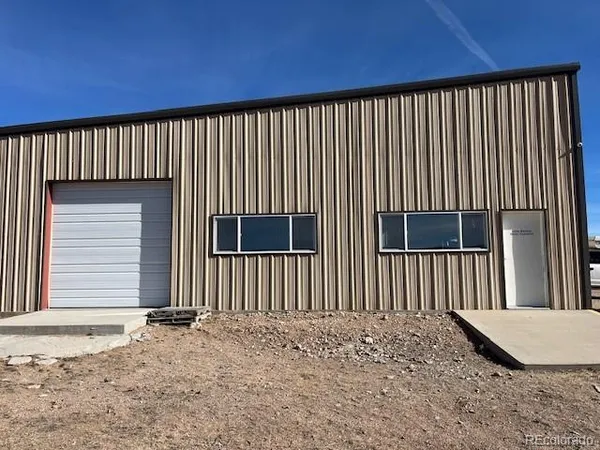 a view of a car park side of a house